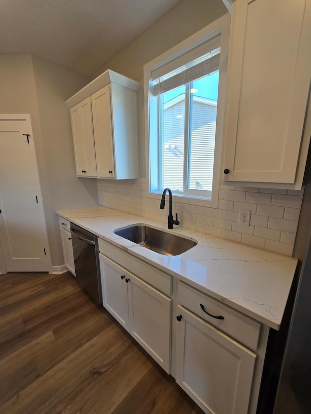 kitchen with dishwasher, white cabinets, dark wood-style floors, and a sink