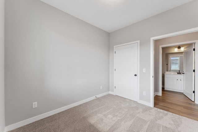 1330 Rose St, New Richmond, WI 54017 - unfurnished bedroom with baseboards, carpet floors, and a sink