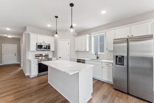1330 Rose St, New Richmond, WI 54017 - kitchen featuring stainless steel appliances, a sink, tasteful backsplash, white cabinetry, and recessed lighting