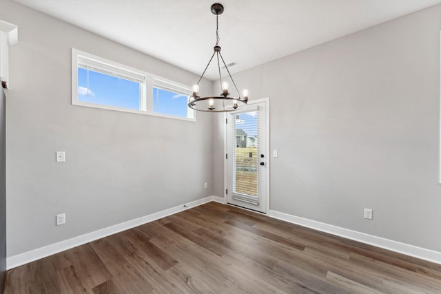 1330 Rose St, New Richmond, WI 54017 - empty room with a chandelier, wood finished floors, and baseboards