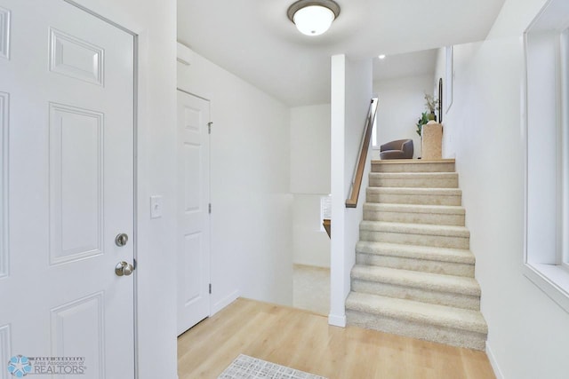 stairway with wood finished floors