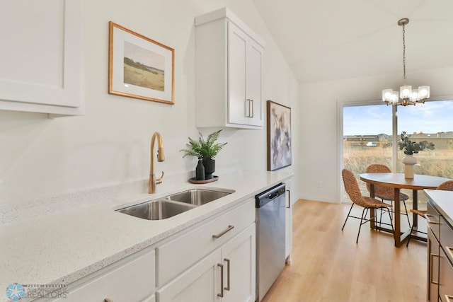 kitchen featuring a sink, dishwasher, white cabinets, and an inviting chandelier