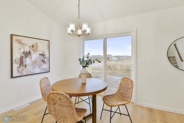 dining area with light wood-style flooring, baseboards, and visible vents