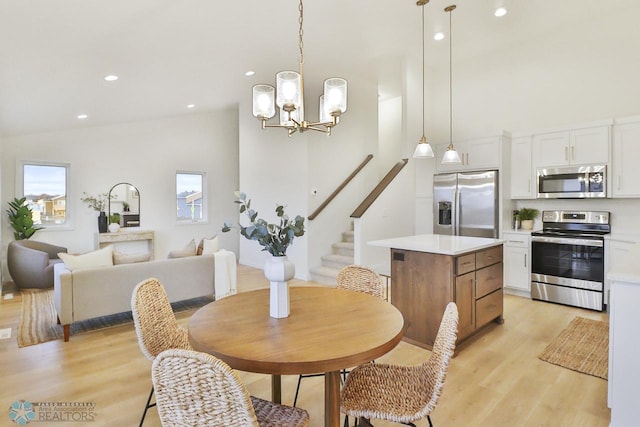 dining area featuring stairway, light wood-style flooring, recessed lighting, and high vaulted ceiling