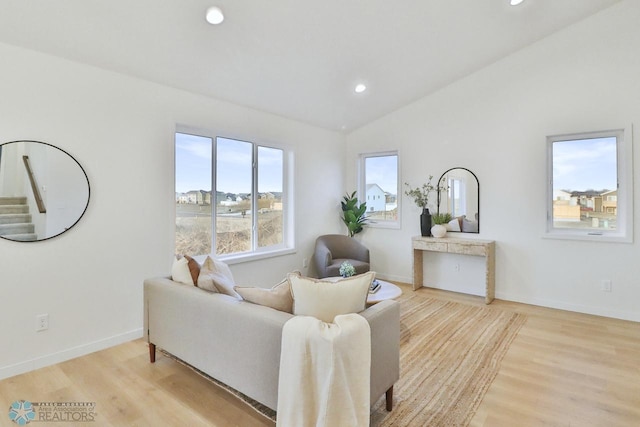 living room with light wood finished floors, recessed lighting, baseboards, and vaulted ceiling