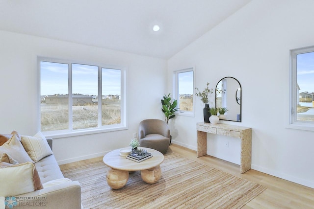 sitting room featuring recessed lighting, light wood-style flooring, baseboards, and lofted ceiling