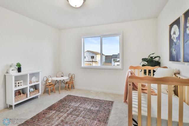 carpeted bedroom featuring baseboards