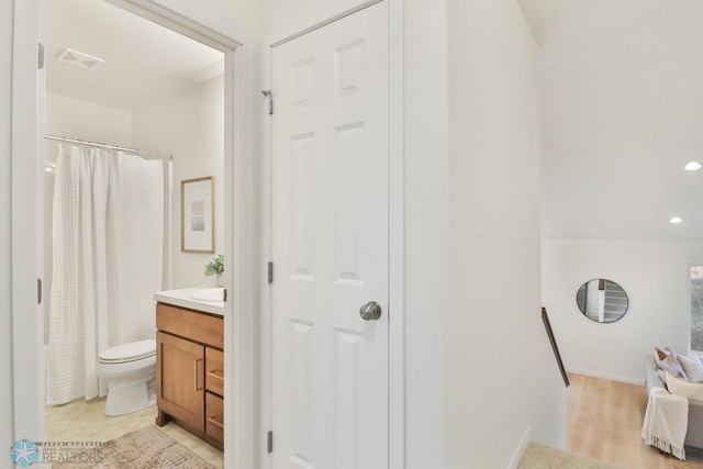 full bath featuring visible vents, toilet, vanity, and a shower with shower curtain