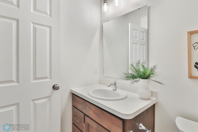 half bath featuring toilet and vanity