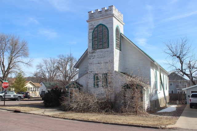 view of side of property featuring fence