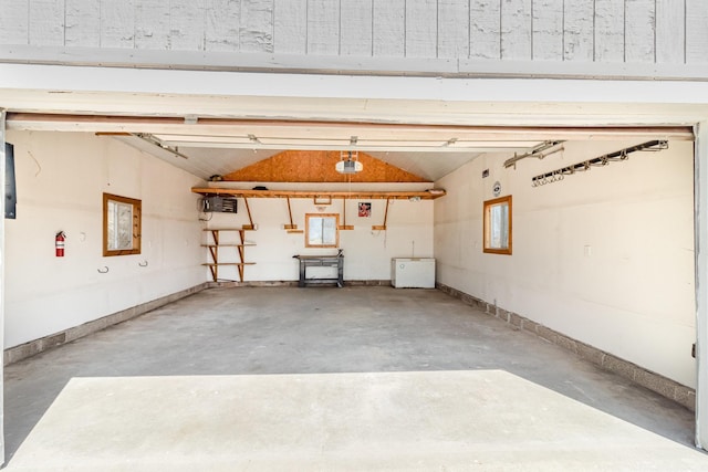 garage featuring baseboards and a garage door opener