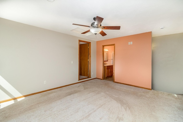spare room featuring baseboards, light colored carpet, and ceiling fan