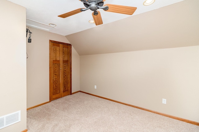 bonus room featuring ceiling fan, light carpet, baseboards, lofted ceiling, and visible vents
