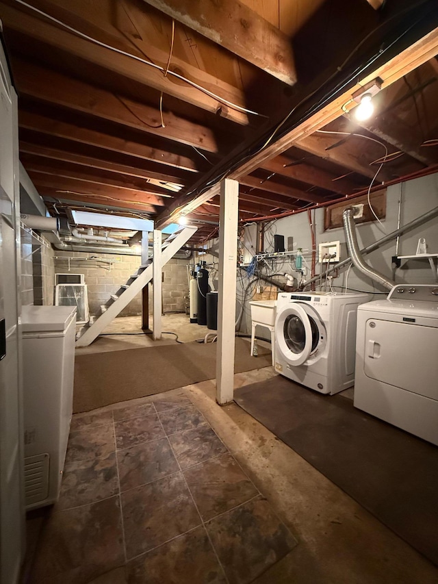 unfinished below grade area with washing machine and dryer and stairway