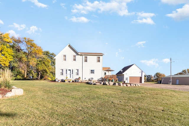 back of property featuring a yard, a detached garage, and driveway
