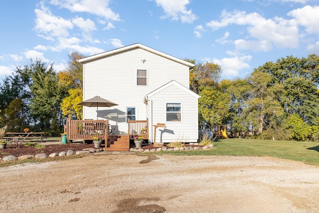 back of house with a yard and a deck
