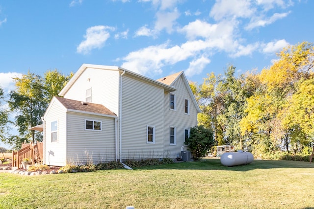 view of home's exterior featuring a lawn and central air condition unit
