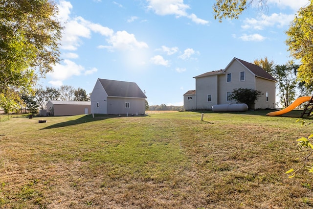 view of yard with an outbuilding and a playground
