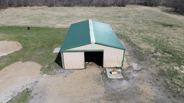 exterior space featuring driveway and an outbuilding