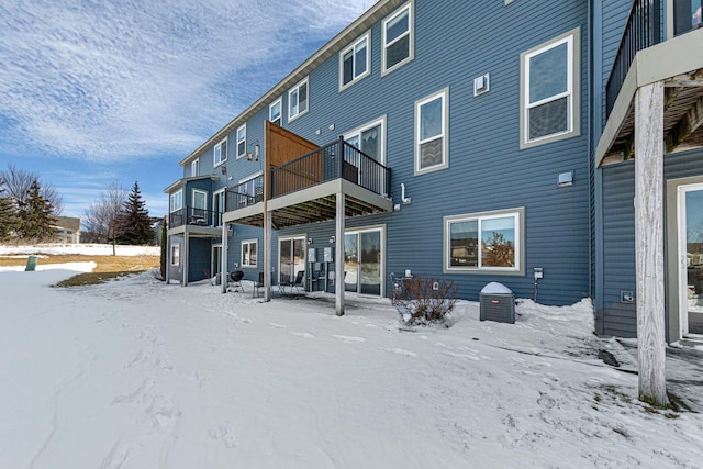 view of snow covered rear of property