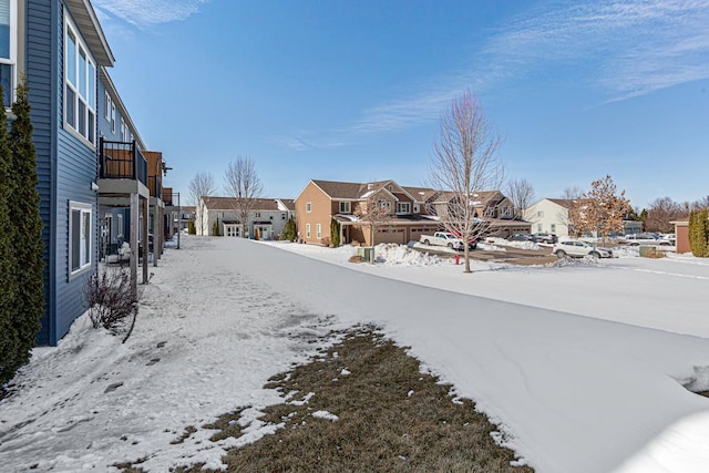 yard covered in snow featuring a residential view