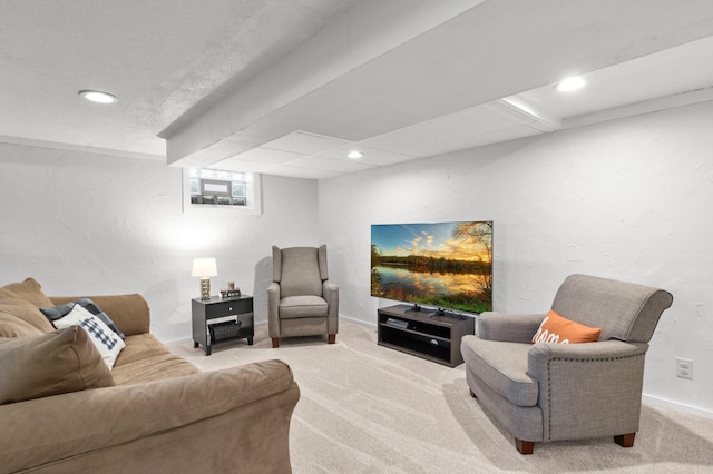 living room with baseboards, recessed lighting, carpet, and a textured wall