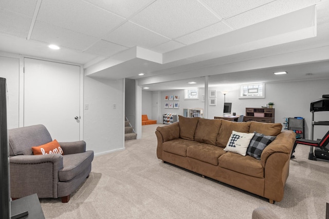 living area with recessed lighting, a paneled ceiling, stairs, and light carpet
