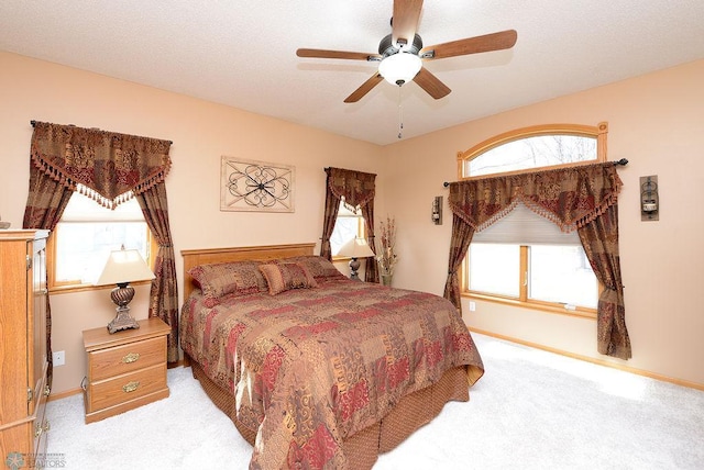 bedroom featuring carpet flooring, a ceiling fan, and baseboards