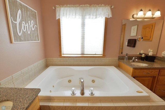 full bath featuring a tub with jets and vanity