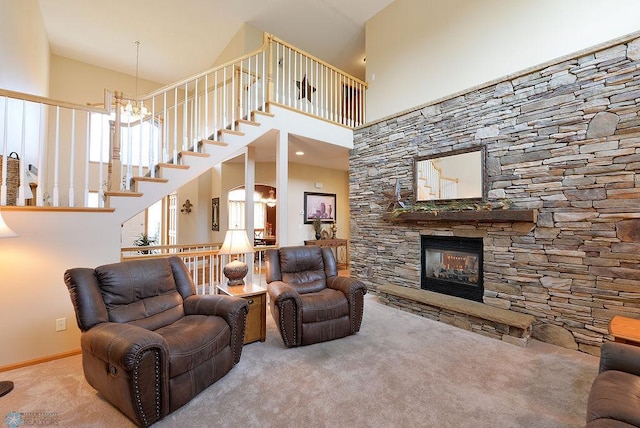 carpeted living area featuring a notable chandelier, stairway, a fireplace, baseboards, and a towering ceiling