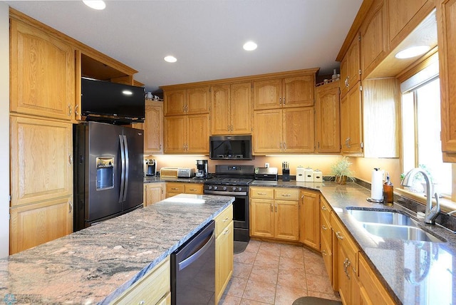 kitchen featuring light tile patterned floors, light stone countertops, recessed lighting, a sink, and appliances with stainless steel finishes