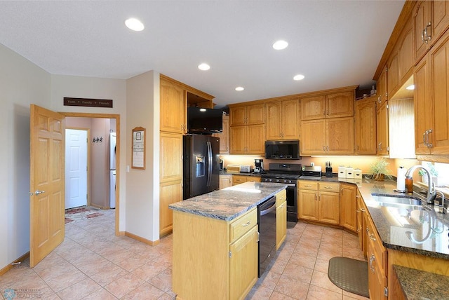 kitchen with a center island, recessed lighting, dark stone countertops, black appliances, and a sink