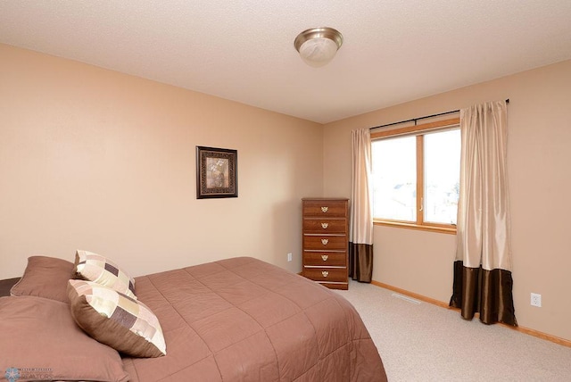 bedroom featuring baseboards and carpet flooring