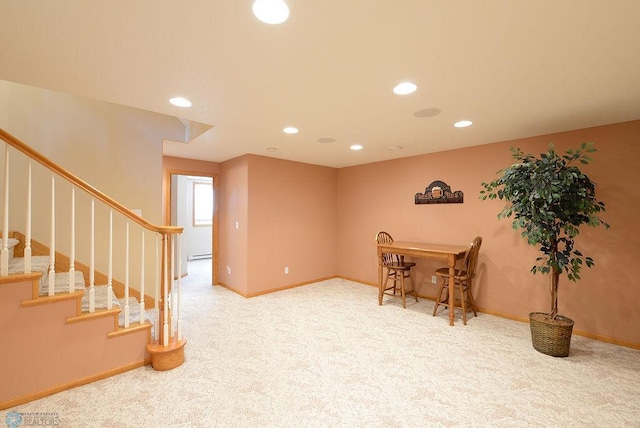 interior space featuring recessed lighting, a baseboard heating unit, baseboards, and carpet floors