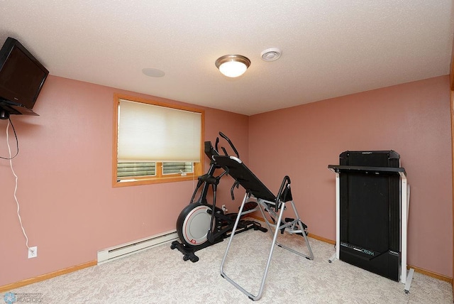 exercise room with a textured ceiling, baseboards, carpet floors, and a baseboard radiator