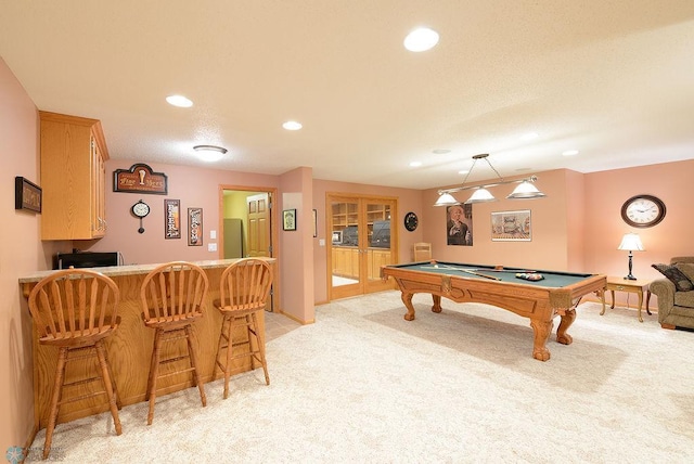 game room featuring billiards, recessed lighting, french doors, a dry bar, and light colored carpet