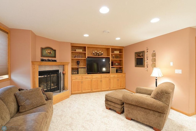 living room with recessed lighting, a fireplace, baseboards, and light carpet