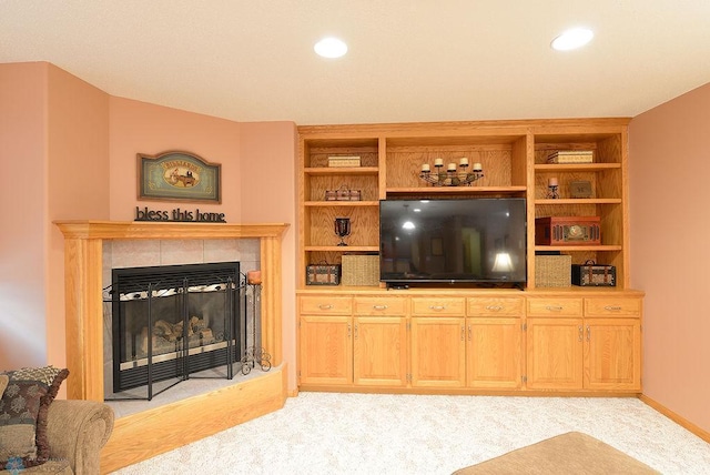 living room with light carpet, built in features, recessed lighting, and a fireplace