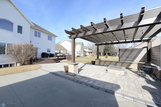 view of patio / terrace featuring a wooden deck, a fire pit, and a pergola