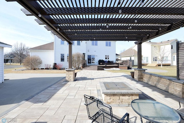 view of patio / terrace featuring an outdoor fire pit, a deck, and a pergola