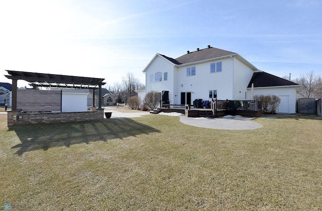 back of house featuring a yard, a deck, and a pergola