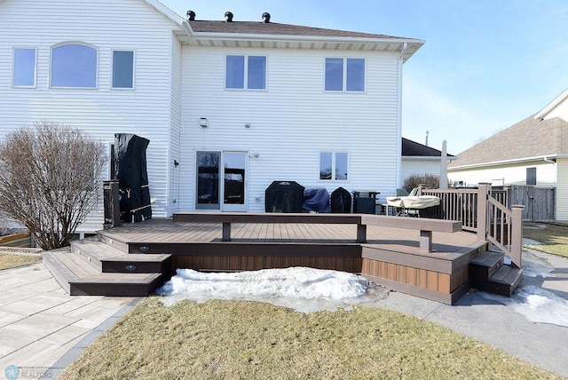 rear view of house featuring a wooden deck