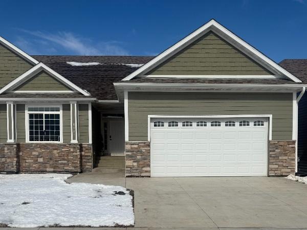 craftsman inspired home featuring concrete driveway and an attached garage