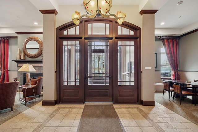 entryway featuring recessed lighting, baseboards, and ornate columns