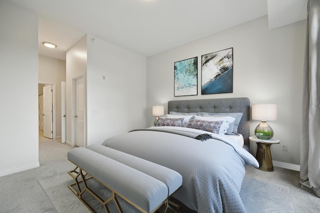 bedroom with baseboards and carpet