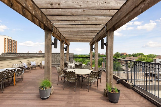 deck featuring a pergola and outdoor dining area