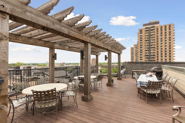 wooden terrace with a pergola and outdoor dining area