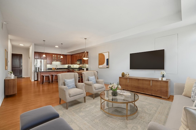 living room with recessed lighting and light wood-type flooring