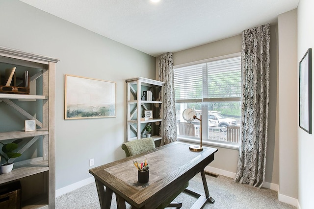 carpeted office with visible vents and baseboards