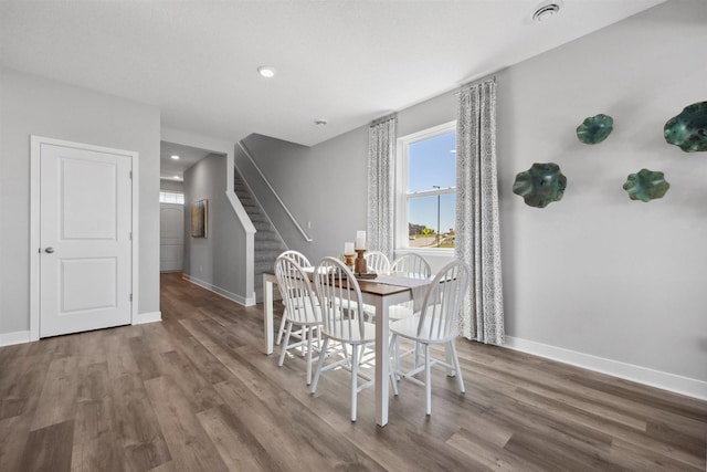 dining space with recessed lighting, stairway, baseboards, and wood finished floors